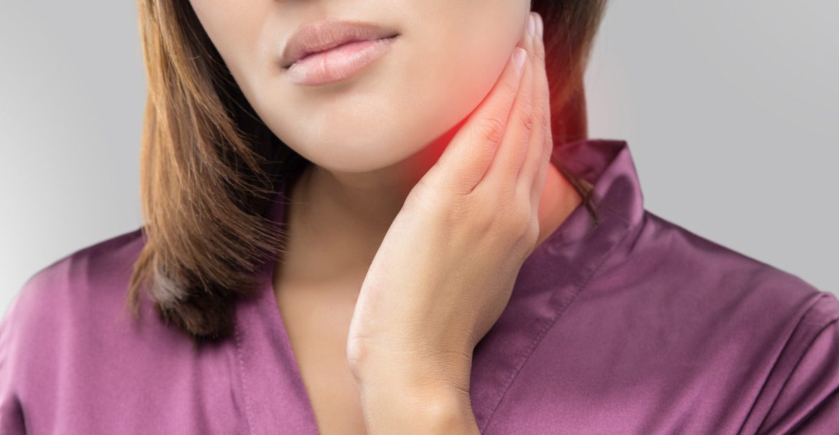 Woman-holding-side-of-neck-and-jaw