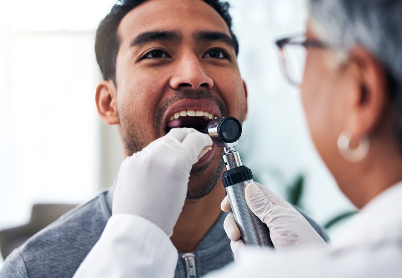 doctor-looking-in-throat-of-patient