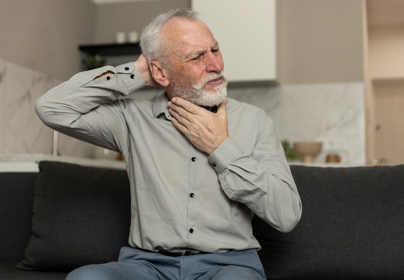 man-holding-head-and-neck-in-discomfort