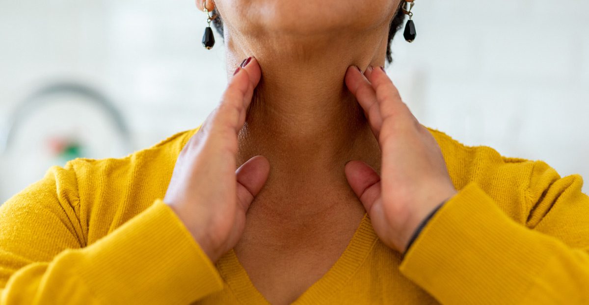 older-woman-holding-outside-of-throat