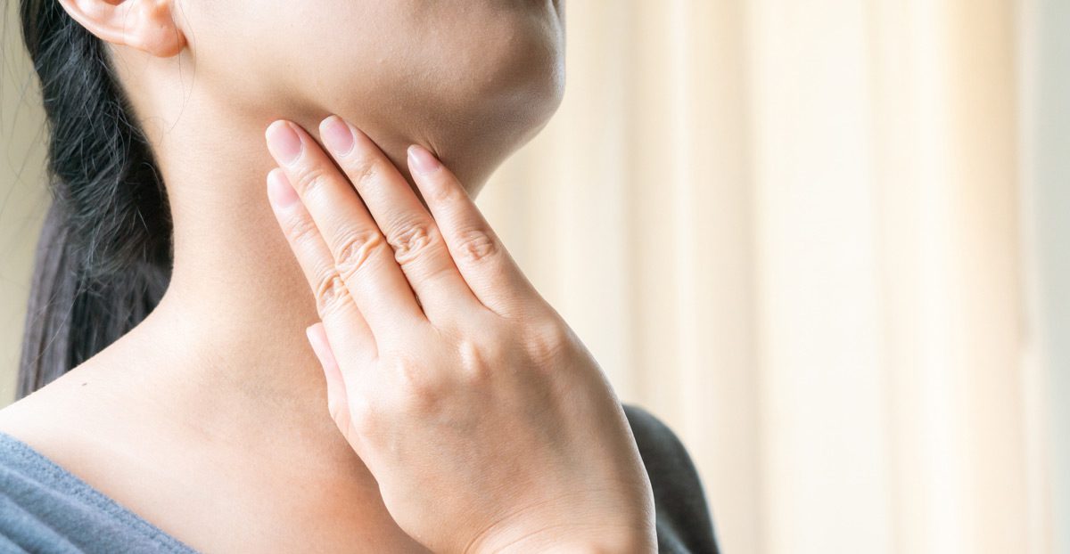 patient-holding-side-of-neck-and-jaw